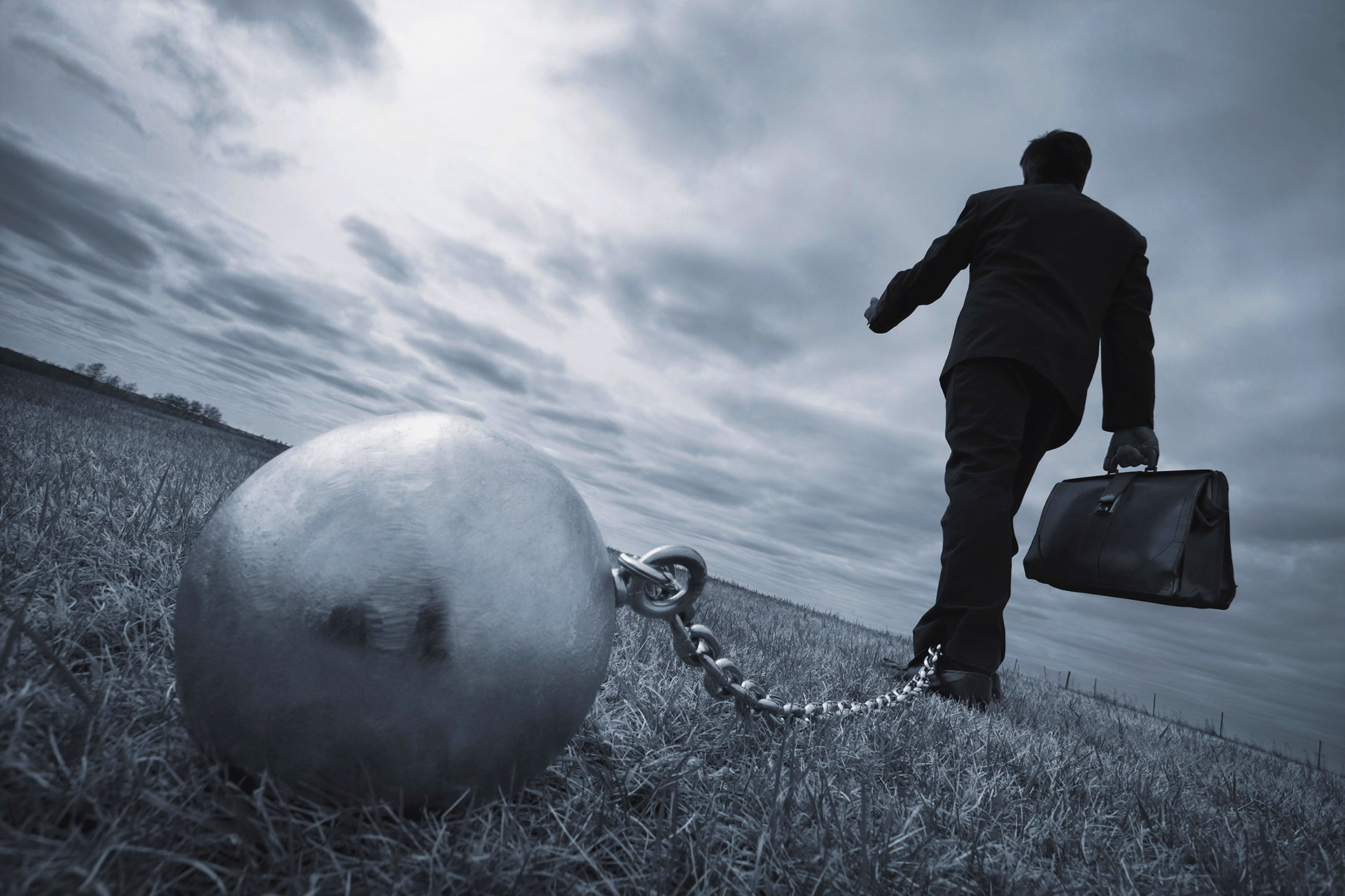 Ball and chain tied to ankle of business as representation of legal burden of proof
